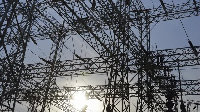 High voltage power lines are prominently displayed at Hoover Dam, capturing the intricate structure against the backdrop of a blue sky in Arizona Nevada.