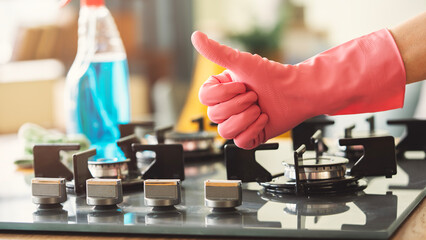 Woman of cleaning cooker indoors at home