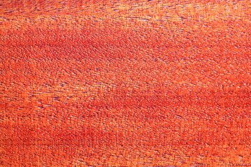 A detailed look at a vibrant red fabric texture.