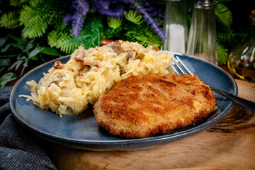 Minced meat cutlet with boiled sauerkraut.