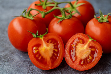 Ripe red tomatoes on wooden background.