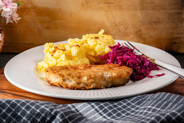 Minced meat cutlet served with mashed potatoes and salad.