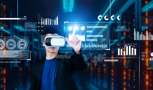 Businessman with headset standing at data center while analyzing financial data. Manager pointing marketing statistic hologram and using augmented reality goggles while making a decision. Ingenuity.