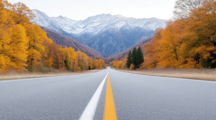 Fototapeta premium Autumn highway through mountains. A paved road stretches into a valley framed by vibrant fall foliage and snow-capped peaks
