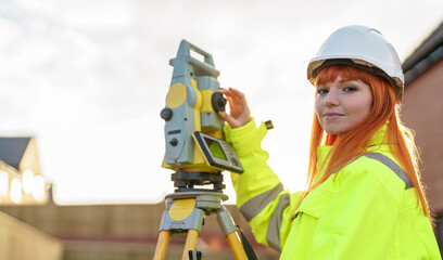 Portrait of Female Surveying expert operating surveying total station instrument