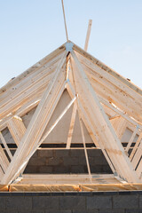 Construction of wooden joist roof structure with beams and trusses