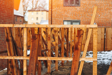 Building boundary fence with posts and timber
