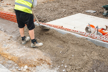 Concrete pin kerb edging installed for new footpath and fixed with semi-dry concrete