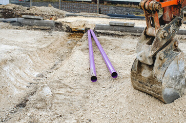 Installation of purple plastic ducts for fiber optic internet cable in developing area