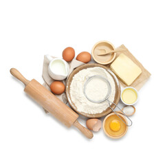 Rolling pin and different ingredients isolated on white, top view