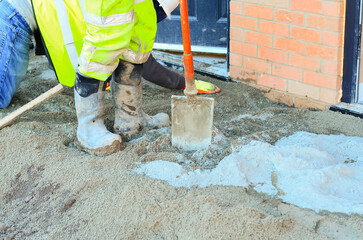 Builder leveling sand bed for concrete paving slab installation