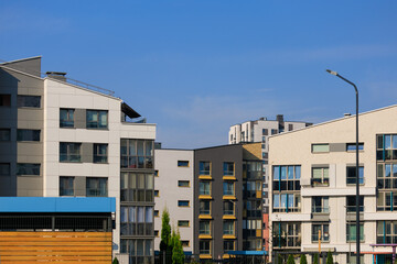 Fototapeta premium City view on a sunny day. Modern houses against the blue sky.