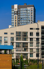 Cityscape on a summer day, modern buildings and houses 