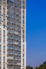City view on a sunny day. Modern houses against the blue sky.