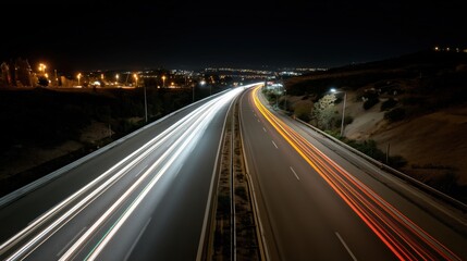 Streaks of light from passing cars paint the night highway, capturing the energy of nonstop motion.

