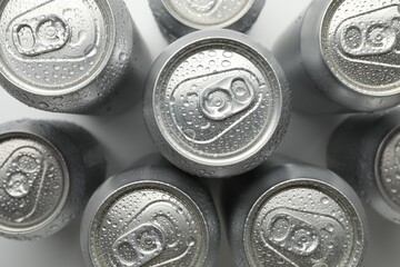 Many different tin cans on light background, top view