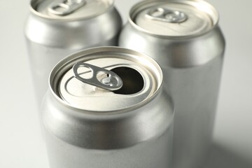 Three tin cans on white background, closeup
