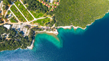 Fototapeta premium Aerial photo of the stunning Limski Kanal and Camping Koversada near Vrsar, Croatia. The landscape features lush greenery, crystal-clear turquoise waters, and winding coastline — a true Adriatic