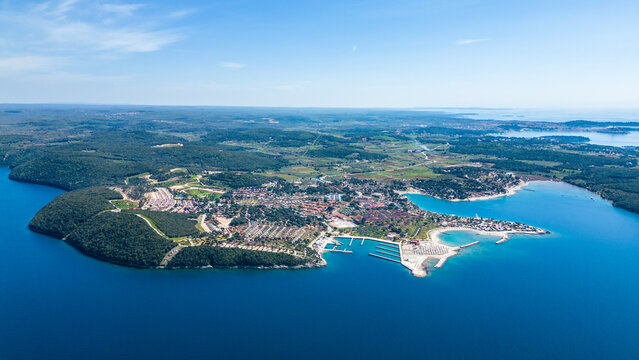 Aerial photo of the stunning Limski Kanal and Camping Koversada near Vrsar, Croatia. The landscape features lush greenery, crystal-clear turquoise waters, and winding coastline &mdash; a true Adriatic