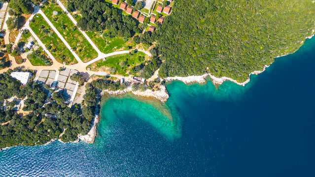 Aerial photo of the stunning Limski Kanal and Camping Koversada near Vrsar, Croatia. The landscape features lush greenery, crystal-clear turquoise waters, and winding coastline &mdash; a true Adriatic