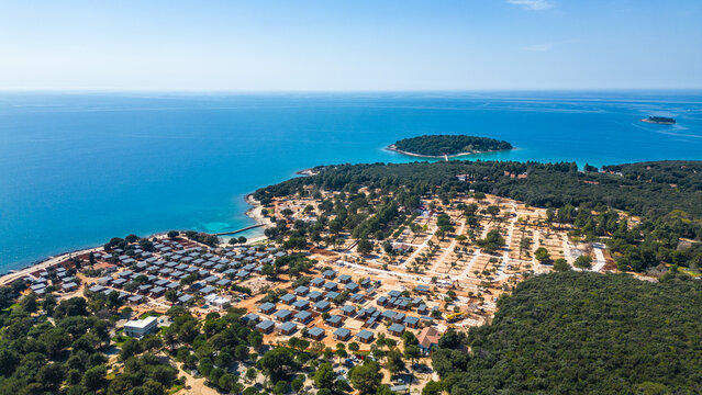 Aerial photo of the stunning Limski Kanal and Camping Koversada near Vrsar, Croatia. The landscape features lush greenery, crystal-clear turquoise waters, and winding coastline &mdash; a true Adriatic