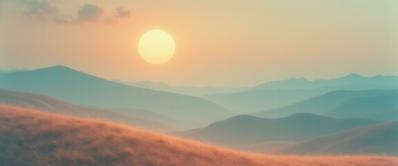 Obraz premium Ethereal sunrise over rolling hills covered with golden grass