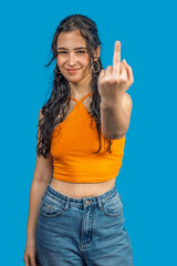 Young woman showing middle finger on blue background