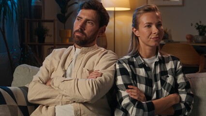 Offended woman man Caucasian couple quarrel ignoring relationship family problem at home night betrayal jealous guy girl husband wife breakup divorce fight sit separated angry frustrated displeased
