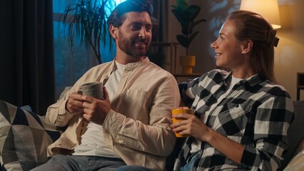 Loving couple Caucasian man woman girl guy happy family at evening home husband wife drinking cups tea casual weekend enjoying drink coffee night insomnia talk cozy relax together healthcare medicine