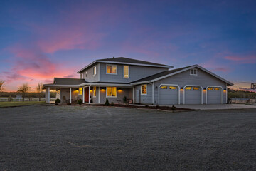 A spacious and large home with an expansive lawn area in front of it