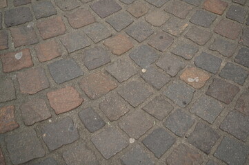 Old cobblestone pavement texture in warm natural tones. Perfect for urban design, architecture backgrounds, construction visuals, and tourism marketing. Symbol of European heritage, stability, and tim