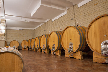 Wine huge barrels in the cellar of wine producer.
