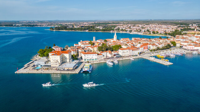 Aerial view of Poreč (Porec), Croatia, showcasing the charming old town, vibrant coastline, and the nearby island of Sveti Nikola. The stunning Zelena Laguna area adds to the beauty turquoise waters