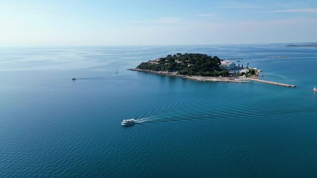 Aerial view of Poreč (Porec), Croatia, showcasing the charming old town, vibrant coastline, and the nearby island of Sveti Nikola. The stunning Zelena Laguna area adds to the beauty turquoise waters