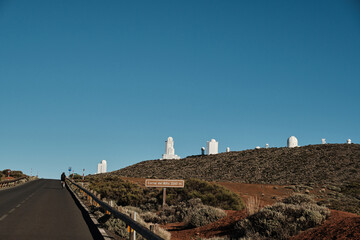 Lonely cyclist on a road leading to the majestic Roque de los Muchachos Observatory on a clear day....