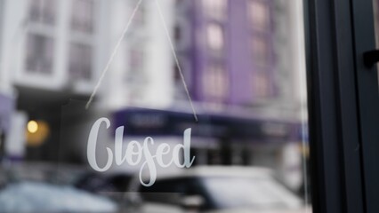 Closed sign board on glass door of cafe, coffee shop is closed for the day