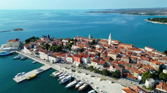 Aerial view of Poreč (Porec), Croatia, showcasing the charming old town, vibrant coastline, and the nearby island of Sveti Nikola. The stunning Zelena Laguna area adds to the beauty turquoise waters