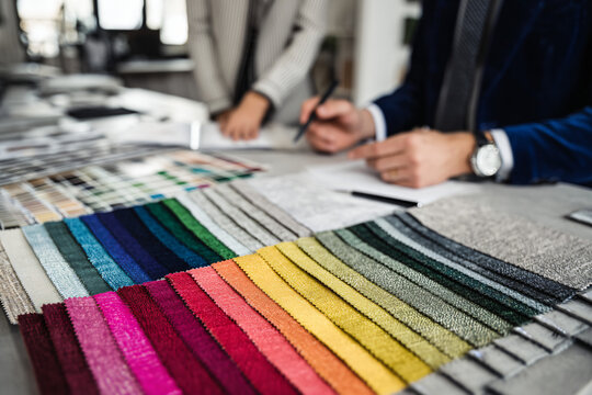 designer selecting upholstery samples for home renovation