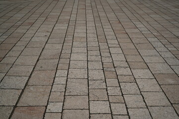 grey geometric paving stones close up, grey geometric tile surface 