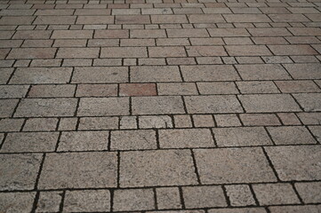 grey geometric paving stones close up, grey geometric tile surface 