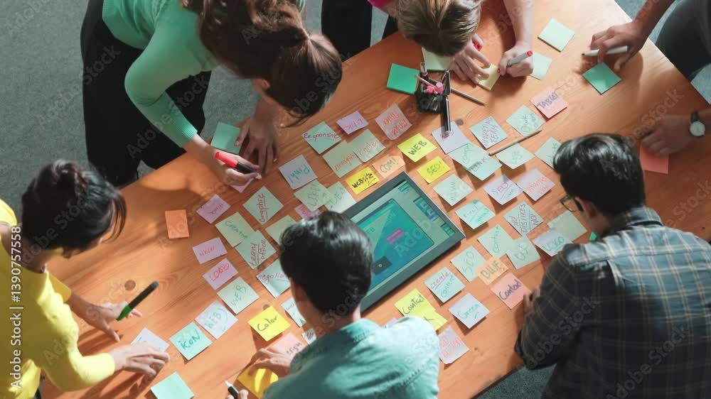 Fototapete Top view of skilled programmer brainstorming idea about mobile phone interface while develop app development by using wireframe prototype. Web designer planning at table with sticky notes. Symposium.