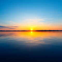 Fototapeta premium Sunset Reflection Over Still Water With Clear Blue Sky And Golden Hues