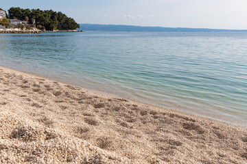 Obraz premium The seashore of the Adriatic sea in Croatia. Pebble beach on the Adriatic sea. The pure sea water.