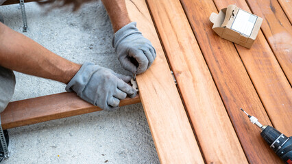 Installing screws on a wooden deck frame