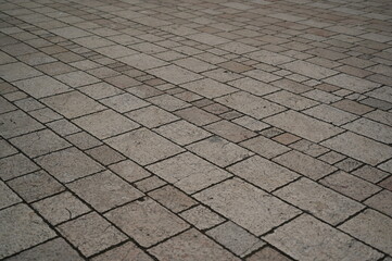 Fototapeta premium grey paving tile texture, grey tile pattern as background, grey tile texture close up 