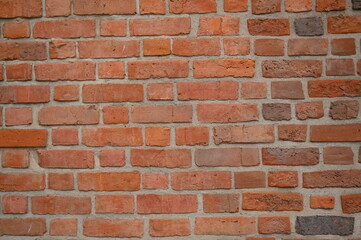 Red brick wall close up background. Vintage masonry texture of red bricks with mortar