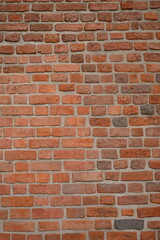 Fototapeta premium Red brick wall close up background. Vintage masonry texture of red bricks with mortar
