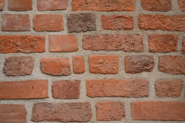 Red brick wall close up background. Vintage masonry texture of red bricks with mortar