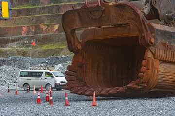 Small van next to an mining shovel bucket