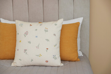 Soft decorative pillows on bed in bedroom